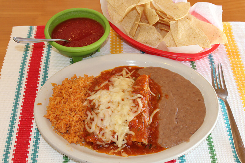 Chicken Enchilladas with ranchero sauce, refried beans and mexican rice.